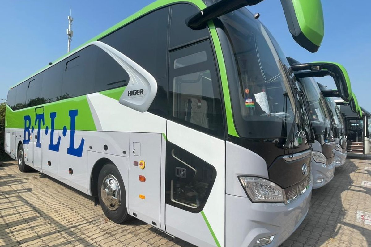 A white and green B.T.L.L. Higer bus
